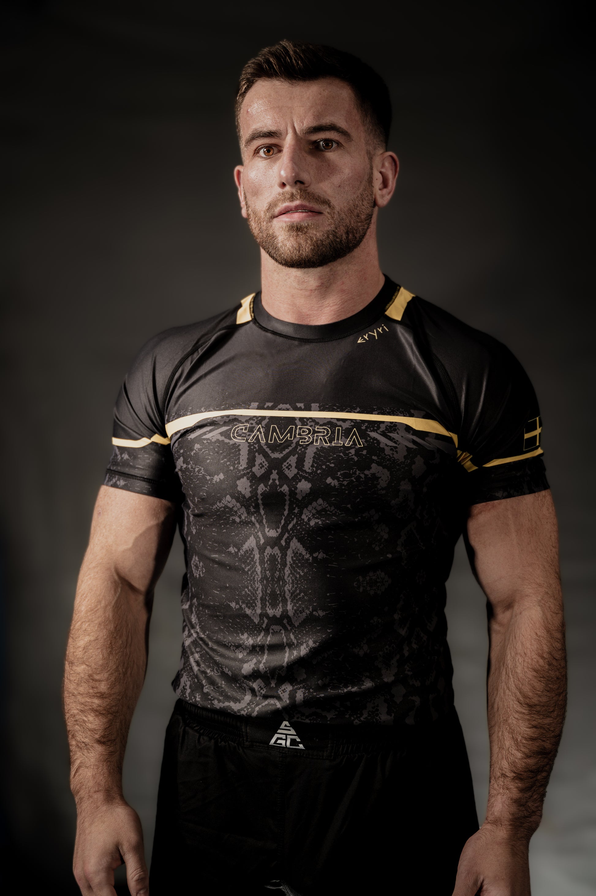 Cambria black and gold Brazilian Jiu-Jitsu rashguard with snakeskin pattern, compression top for no-gi BJJ training and competition