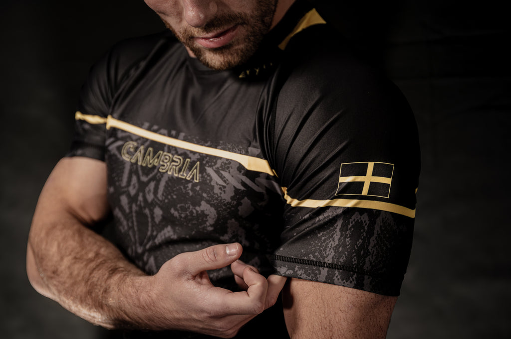 Cambria black and gold Brazilian Jiu-Jitsu rashguard with snakeskin pattern, compression top for no-gi BJJ training and competition