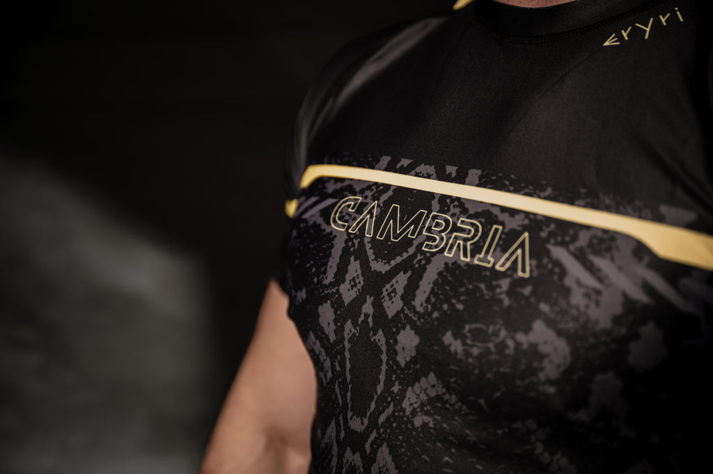 Cambria black and gold Brazilian Jiu-Jitsu rashguard with snakeskin pattern, compression top for no-gi BJJ training and competition