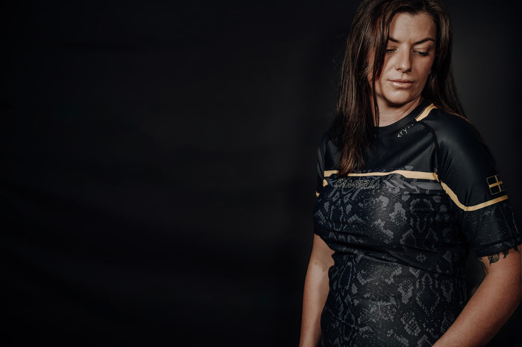 Cambria black and gold Brazilian Jiu-Jitsu rashguard with snakeskin pattern, compression top for no-gi BJJ training and competition. unisex - men and women.